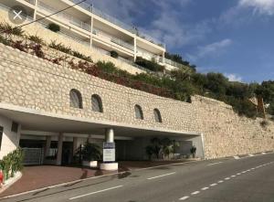 a large brick building with a road in front of it at La terrazza di monaco in Cap d'Ail +18 photos