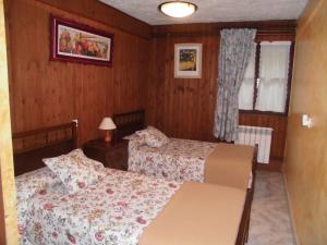 a small bedroom with two beds and a window at El Molino in Arenas de Cabrales +82 photos
