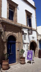ein Gebäude mit blauen Türen und einem Schild davor in der Unterkunft Casa Lila & Spa in Essaouira