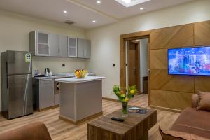 a kitchen and living room with a couch and a table at Classical Hotel Suites in Jeddah