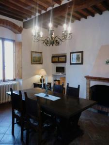 a dining room with a table and a fireplace at Torre rossa in Bolgheri