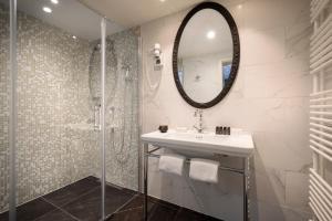 a bathroom with a sink and a mirror at Hotel Imperial - Liburnia in Opatija