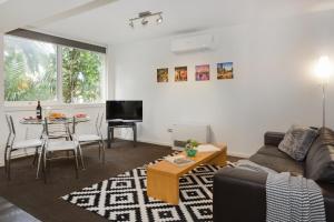 a living room with a couch and a table at Melbourne Villa in Melbourne