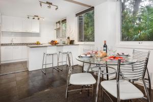 a kitchen with a table with chairs and a counter at Melbourne Villa in Melbourne