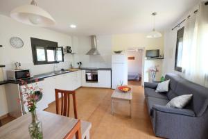a living room with a couch and a table at TURISMe RURAL EMPORDA in Torroella de Montgrí