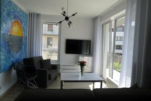 Telewizja i/lub zestaw kina domowego w obiekcie Impresja 42 Apartament z garażem