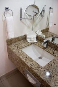 a bathroom counter with a sink and a mirror at Bahia Escondida in Santiago