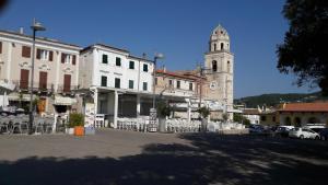 a building with a clock tower and a church at Appartamento mare Sirolo con garage privato in Sirolo