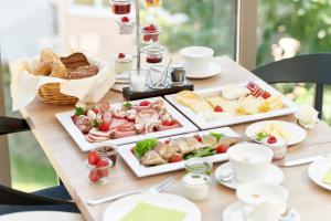 a table with three trays of food on it at Designhotel Whitman in Ascheberg