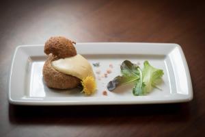 a white plate with a dessert on a table at Il Feudo in Vo Euganeo