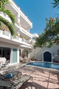 a villa with a swimming pool and a building at Casa Agua Azul in Puerto Morelos