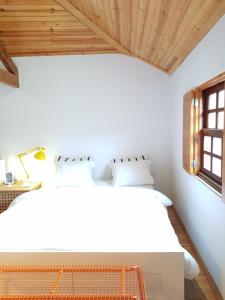 a bedroom with two beds and a window at Casa de Sistelo - Turismo Rural Gerês in Sistelo