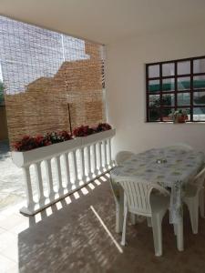 a table and bench in a room with a window at Apartments Stipanovic in Biograd na Moru