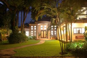 a house with a garden at night at Zawadi House Lodge in Arusha