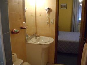 a bathroom with a sink and a toilet and a shower at Hôtel Restaurant Anglade in Le Nayrac +32 photos