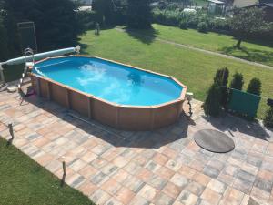 a large swimming pool in a yard with a patio at Ferienhaus Miklin in Bleiburg