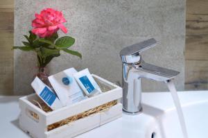 a bathroom sink with a flower in a holder at B&B Il Lentisco in Camerota +65 photos