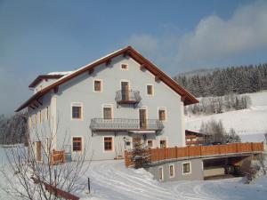 a large white house in the snow at Haus Bliem in Flachau