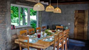 a dining room with a wooden table and chairs at Family Orchard Bed & Breakfast in Angol