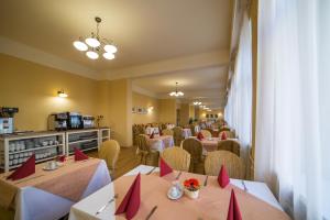 a restaurant with tables and chairs with red napkins at Hotel Luisa in Františkovy Lázně +17 photos