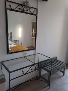 a glass table in front of a mirror at Mariliza Beach Hotel in Marmari
