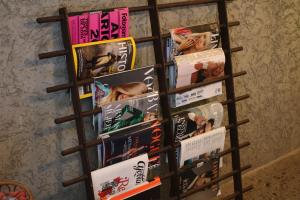 a book rack filled with books on a wall at Kook Hotel Tarifa in Tarifa