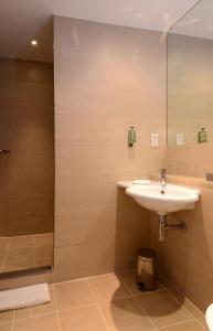 a bathroom with a sink and a shower at International Hotel Telford in Telford