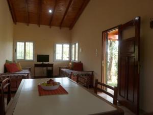 a living room with a table with a bowl of fruit on it at El Pinar - Hospedaje Serrano in Tanti