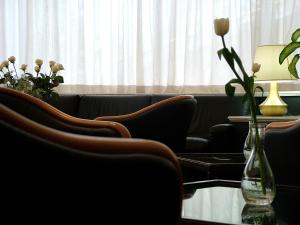a living room filled with furniture and flowers at Forum Palace Hotel in Cassino