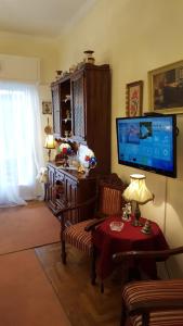 a living room with a flat screen tv and a table at KOKONI APARTMENT De'Luxe CENTRAL ATHENS in Athens