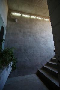 a stairway with a sign that says nobody knows what i really want at Kook Hotel Tarifa in Tarifa