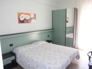 Postel nebo postele na pokoji v ubytování Hotel Palm Beach
