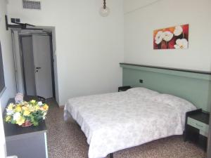 Postel nebo postele na pokoji v ubytování Hotel Palm Beach