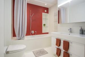 a bathroom with a toilet and a sink at KoBi Apartments Hirschenplatz in Lucerne