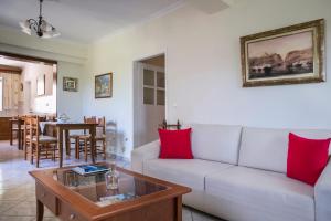 a living room with a couch and a table at Apartment Voula Myrtos in Anomeriá