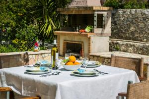 a table with a white table cloth with fruit on it at Apartment Voula Myrtos in Anomeriá