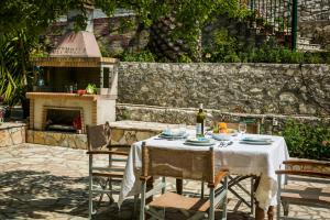 a table with a bottle of wine on top at Apartment Voula Myrtos in Anomeriá