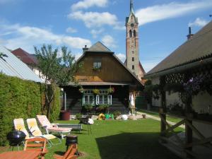 a building with a church with a clock tower at Chalupa Matej in Liptovská Osada