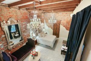 a living room with a couch and a mirror at French Quarter Mansion in New Orleans