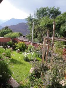 a garden with a fence and flowers at Kay Pacha in Tilcara