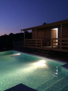 a swimming pool in front of a house at night at Monte Loureiro-caveira in Melides