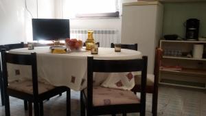 une table avec deux chaises et un tissu de table blanc dans l'établissement Apartman Milada Vrvilo, à Matulji