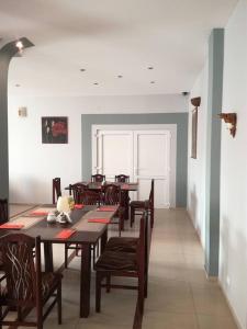 a dining room with wooden tables and chairs at Zajazd Bachus in Czarnocin