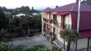 a building with a purple roof and balconies on it at Guest House Vitali in Gonio