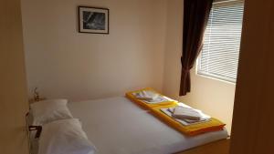 a bedroom with a bed with towels on it at Cozy apartment in Jezera
