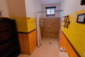 a bathroom with a shower and a toilet at Hacienda Antigua Villa, 50m from sandy Beach in El Cuyo