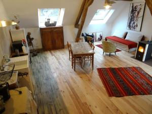 a living room with a table and a couch at L'escalier des rêves - Quadruple confort in Saint-Sauveur-en-Puisaye