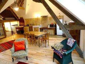 a large living room with a table and chairs at L'escalier des rêves - Quadruple confort in Saint-Sauveur-en-Puisaye