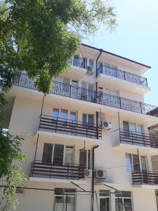 an apartment building with balconies on the side of it at Къща за гости Янка in Nesebar