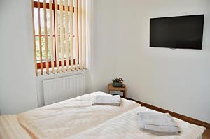 Säng eller sängar i ett rum på Penzion Pod Kaštanem